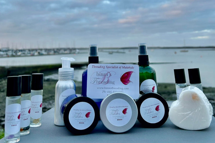 Collection of skincare products on a table with a scenic background
